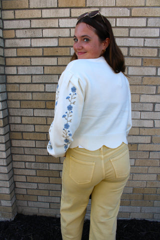 Back view of ivory Flora Knit Sweater with blue embroidered sleeves