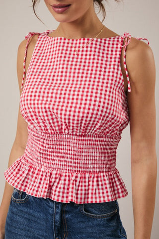 Red and white gingham checkered top bow tie ruched waist worn by a person on a plain background.