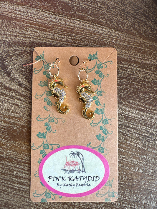 Gold seahorse dangle earrings with crystal detailing and twist hook design, handmade by Pink Katydid exclusively available at Erin Rose Boutique