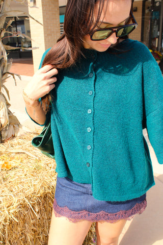 Close-up of Hailey peacock green cardigan featuring textured knit and coordinating buttons.