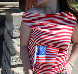 Woman wearing the Harper red and white striped off-the-shoulder top