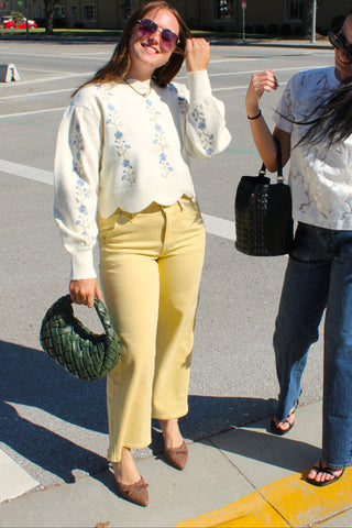 JBD butter yellow straight leg ankle jeans styled with an ivory embroidered sweater and brown pointed flats