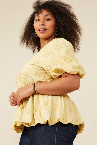Side view of Model wearing Lydia crochet eyelet bubble peplum top with puff sleeves and bubble hem, styled on a plus-size body for a flattering fit. Available at Erin Rose Boutique
