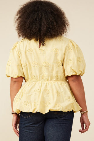 Backside of Model wearing Lydia crochet eyelet bubble peplum top with puff sleeves and bubble hem, styled on a plus-size body for a flattering fit. Available at Erin Rose Boutique