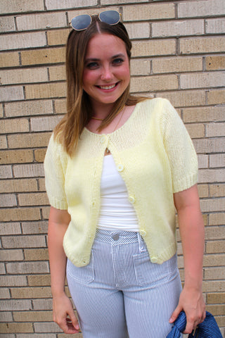 Butter yellow lightweight knit cardigan with striped pants and white tank.