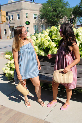 Women wearing the Mason striped smocked dress from Erin Rose Boutique