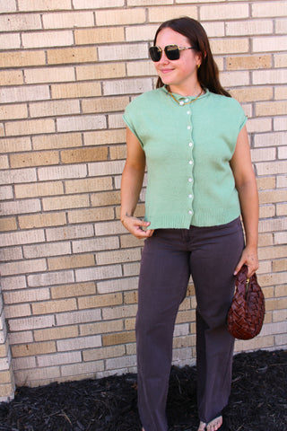 Matcha green knit vest styled with chocolate brown denim