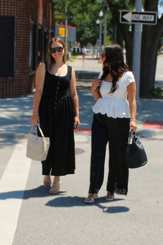 Elegant boutique black satin pants with lace detailing that create a polished and feminine look.