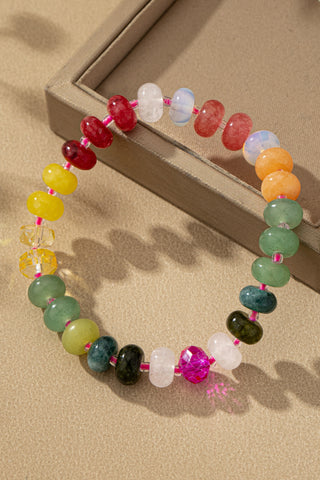 Colorful agate beaded gemstone bracelet with stretchy band on neutral background