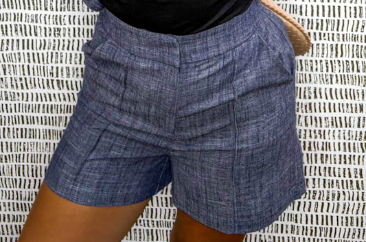 Close-up of navy linen-blend tailored shorts with pleats and high-waist fit at Erin Rose Boutique