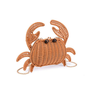 Close-up of the Sebastian Woven Crab Clutch Bag showcasing its woven texture, crab silhouette, and removable chain strap.