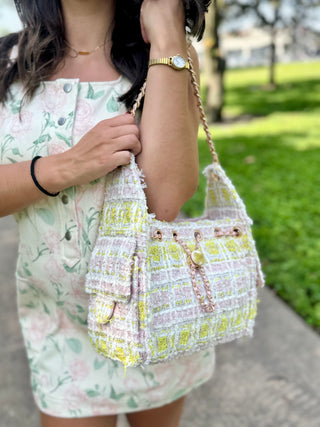 Paisley Tweed Shoulder Bag in pastel pink, yellow, and ivory tweed with gold chain accents and a woven shoulder strap.