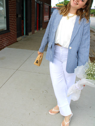 Blue gingham oversized blazer styled with white denim and a neutral clutch for a polished coastal chic outfit