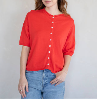 Red short sleeve button-up cardigan knit top for women styled casually with jeans; lightweight and relaxed fit sweater perfect for everyday wear.