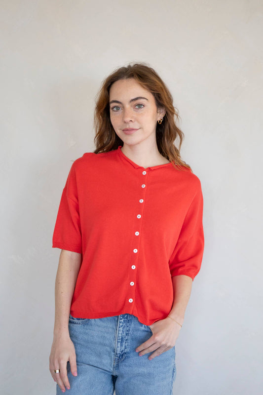 Red short sleeve button-up cardigan knit top for women styled casually with jeans; lightweight and relaxed fit sweater perfect for everyday wear.