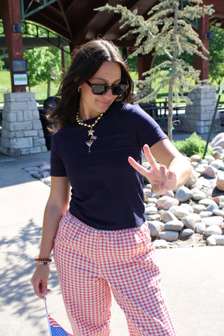 Red and white gingham wide-leg pants styled for a casual summer outfit.