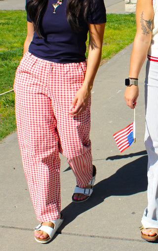 Women's red gingham barrel-leg pants with an elastic waist and relaxed fit.