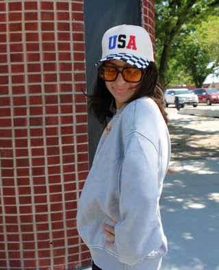 Vintage-inspired USA hat with trendy black and white checkered print brim.