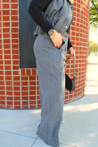 Women's side view of gray denim trousers with relaxed wide leg fit