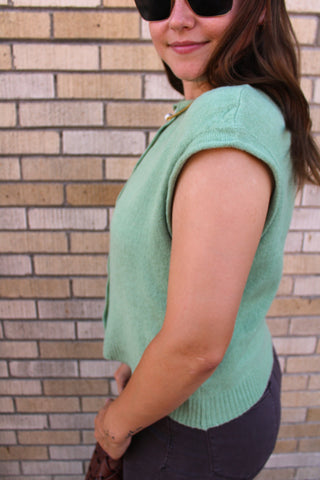 Side view of Women's matcha green cardigan vest with rolled sleeves