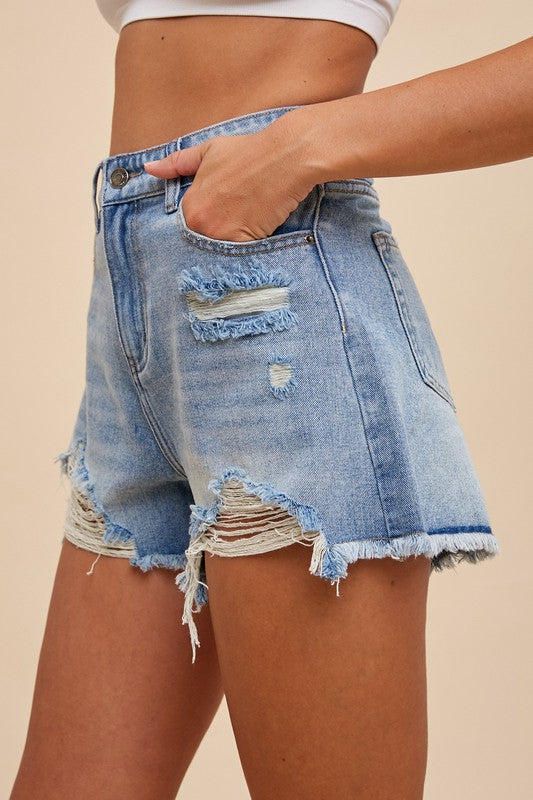 Side view of distressed denim shorts with frayed hem and classic pockets, Erin Rose Boutique