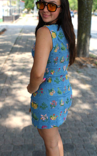 Sleeveless blue mini dress with colorful floral embroidery and a flattering fitted silhouette.