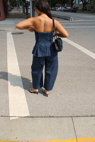 Back view of woman wearing Indigo pinstripe peplum top and pants outfit