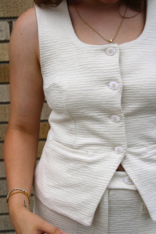 Women's textured tailored top featuring a sophisticated button-front design.