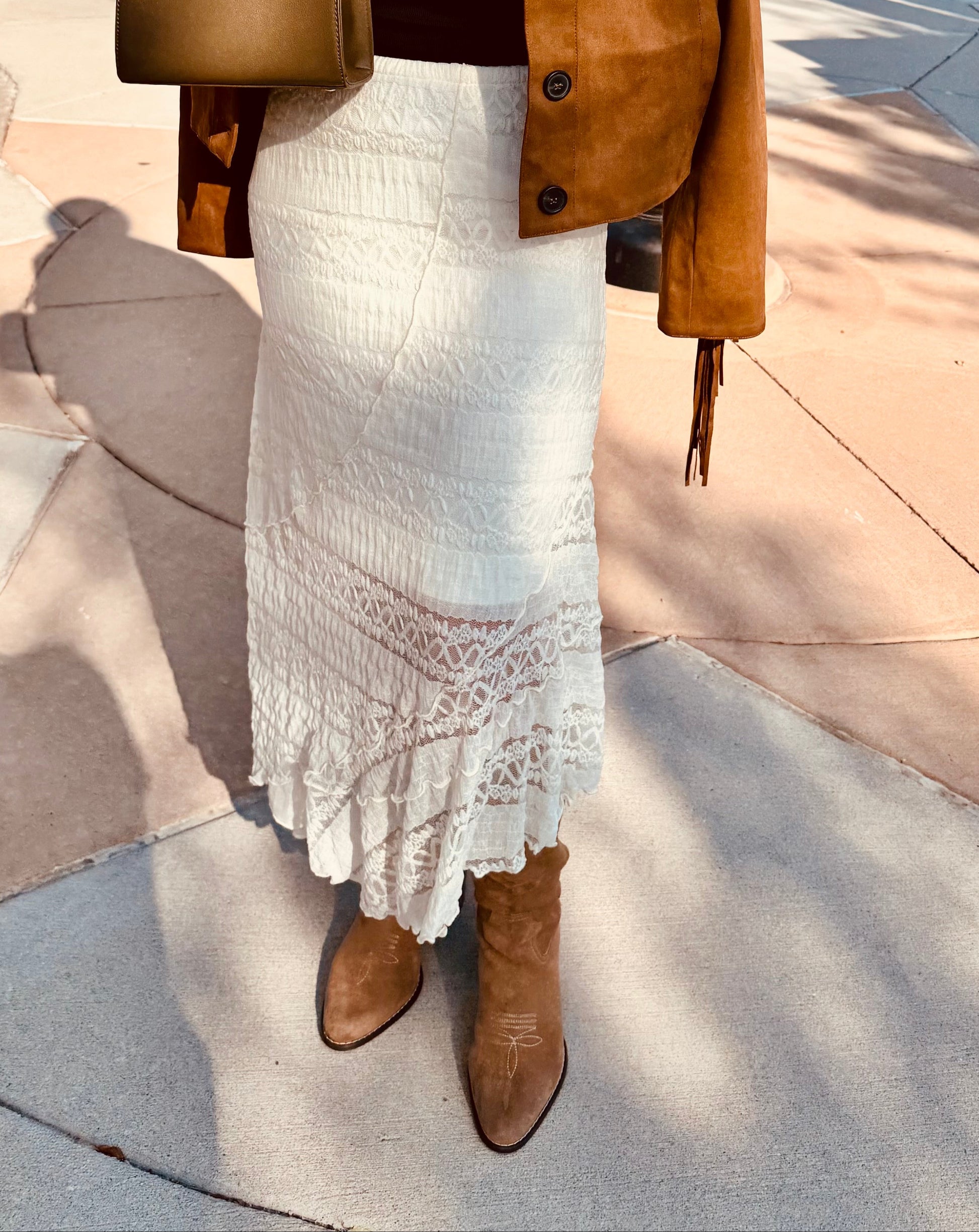 women wearing lace skirt with asymmetrical hem and western boots. 