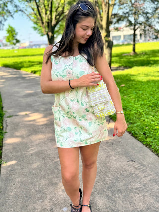 Women's floral button-front mini dress featuring a relaxed fit and sleeveless design.