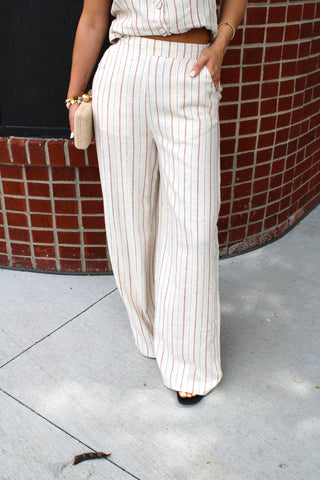Neutral striped linen blend wide-leg pants with side pockets.