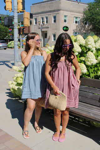 Women’s striped smocked mini dresses in mauve-pink and blue