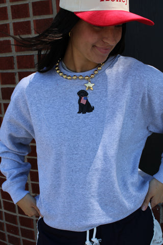 Grey crewneck sweatshirt with black puppy Americana graphic holding a small American flag, casual oversized style